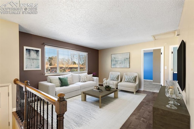 living room with hardwood / wood-style floors and a textured ceiling