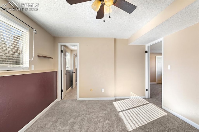 carpeted spare room with a textured ceiling