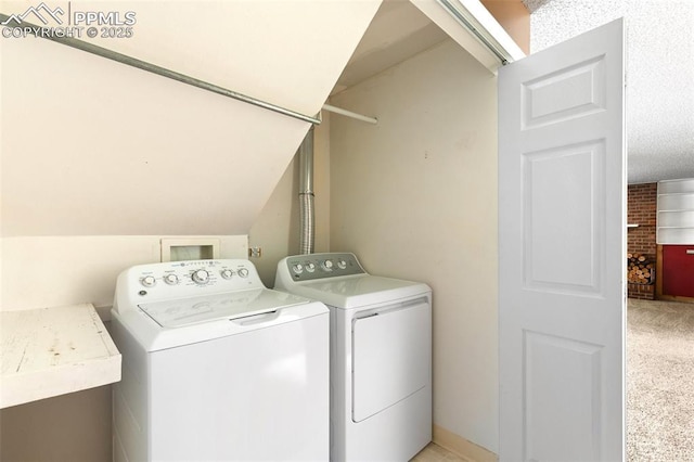 clothes washing area featuring light carpet and washer and clothes dryer