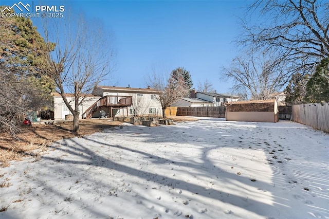 snow covered property with a deck