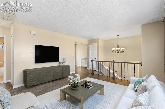 living room featuring dark hardwood / wood-style floors and a textured ceiling