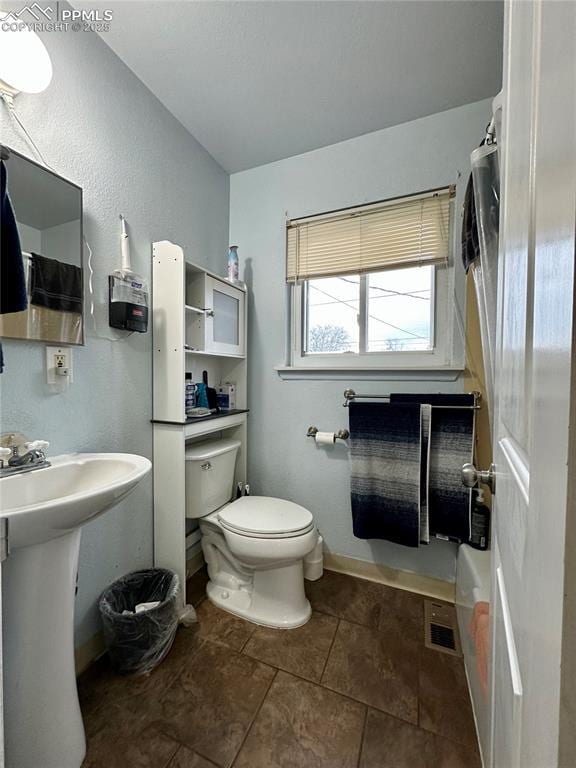 bathroom with tile patterned flooring, sink, and toilet