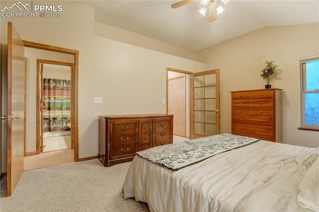 bedroom with vaulted ceiling, light carpet, and ceiling fan