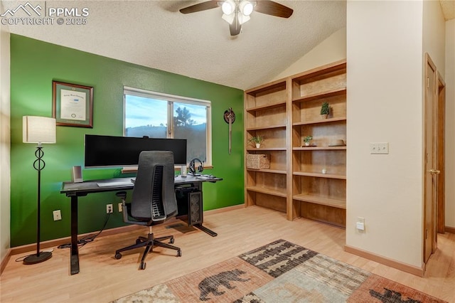 office area with ceiling fan, vaulted ceiling, light hardwood / wood-style flooring, and a textured ceiling