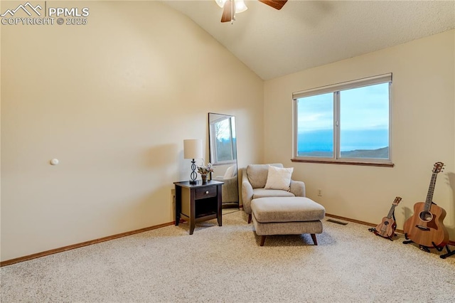 sitting room with ceiling fan, lofted ceiling, and light carpet