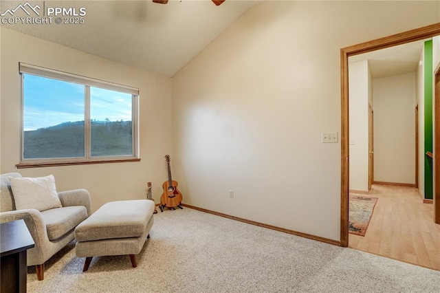 living area featuring lofted ceiling, light carpet, and ceiling fan