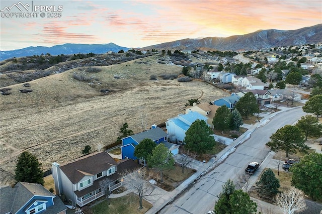 aerial view at dusk featuring a mountain view