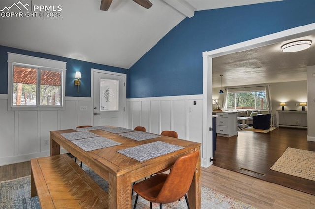 dining space with lofted ceiling with beams, ceiling fan, and light hardwood / wood-style floors