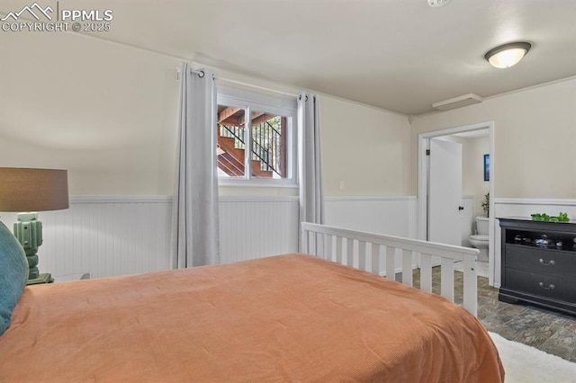 bedroom with wood-type flooring and ensuite bathroom