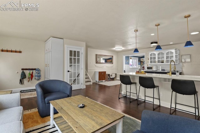 living room with sink and dark hardwood / wood-style floors