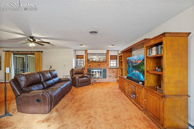 carpeted living room featuring a baseboard heating unit, a brick fireplace, a textured ceiling, and ceiling fan