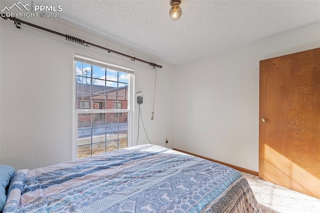 carpeted bedroom with a textured ceiling