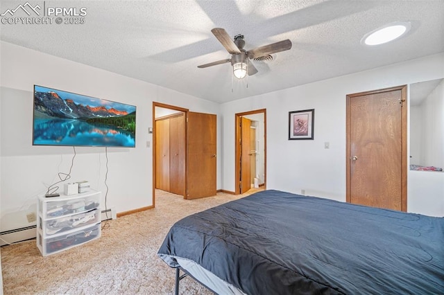 bedroom featuring ceiling fan, light colored carpet, a textured ceiling, and baseboard heating