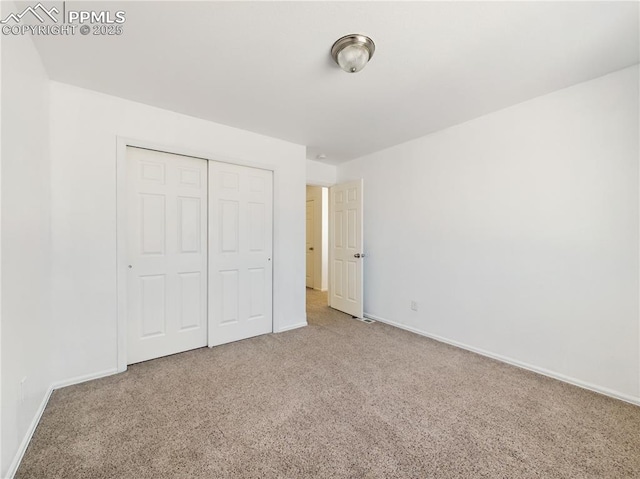 unfurnished bedroom with carpet flooring and a closet