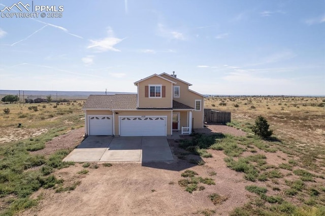 view of front of house featuring a rural view and a garage