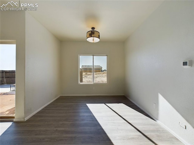 spare room featuring dark hardwood / wood-style flooring