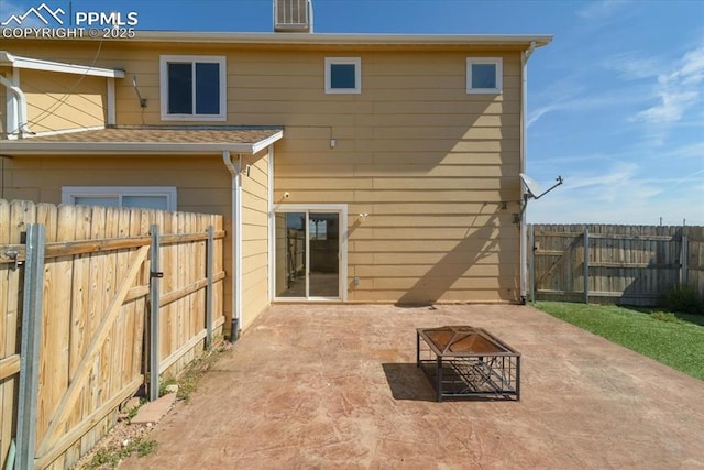 rear view of house featuring a fire pit and a patio area