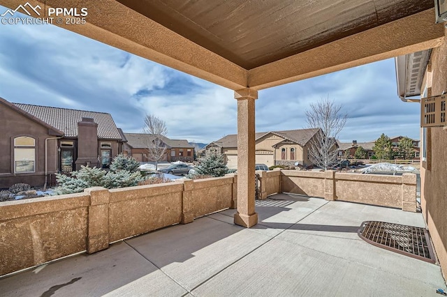 view of patio / terrace with fence and a residential view