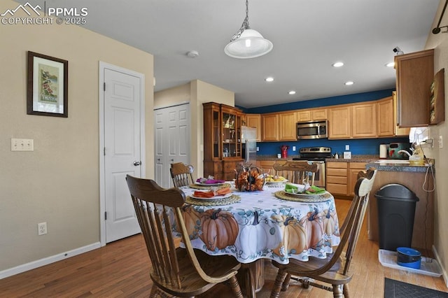 dining room with sink and hardwood / wood-style flooring