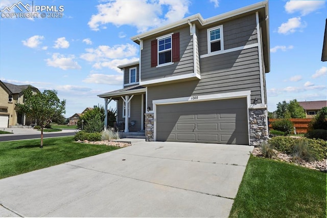 view of front of house with a garage, a front yard, and covered porch