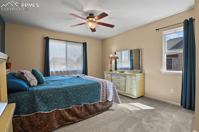 bedroom with multiple windows, light colored carpet, and ceiling fan