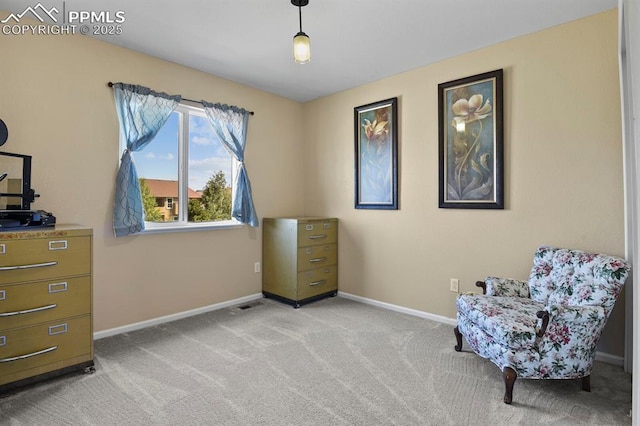 sitting room featuring light colored carpet