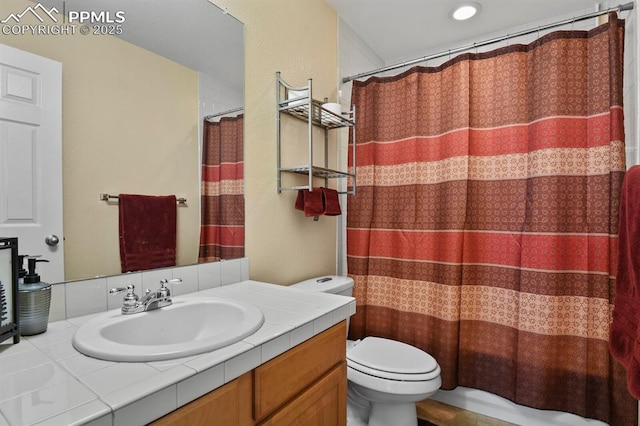 bathroom featuring vanity, curtained shower, and toilet