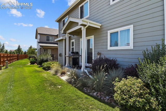 rear view of house with a yard