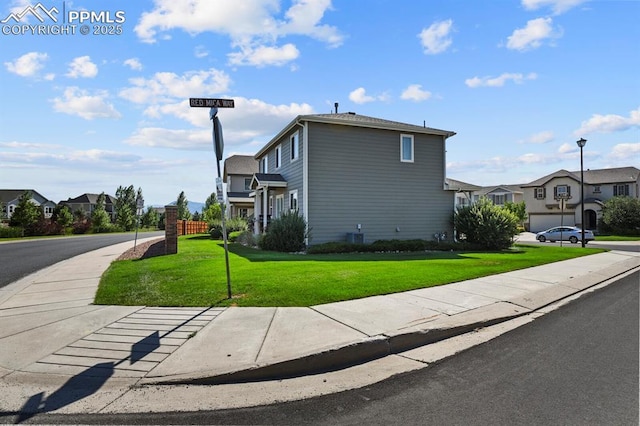 view of side of home with a yard and a garage