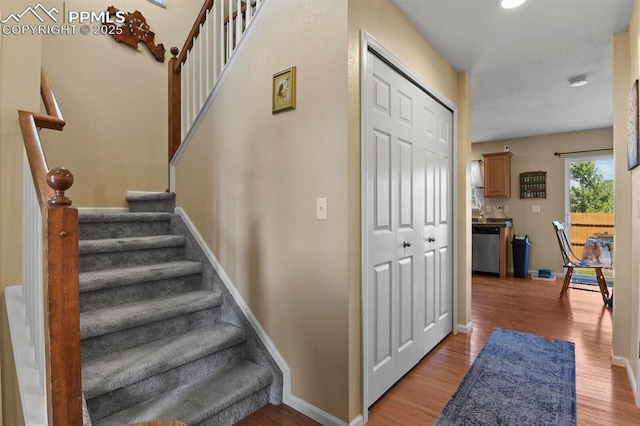 stairs with hardwood / wood-style floors