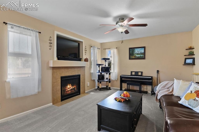 living room with ceiling fan, a fireplace, and light carpet