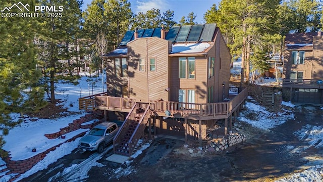 snow covered house with a deck