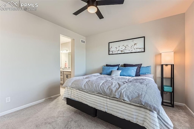 carpeted bedroom with connected bathroom and ceiling fan