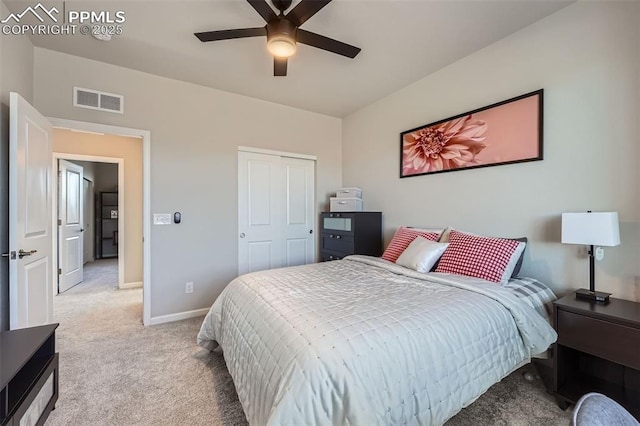 carpeted bedroom featuring ceiling fan and a closet