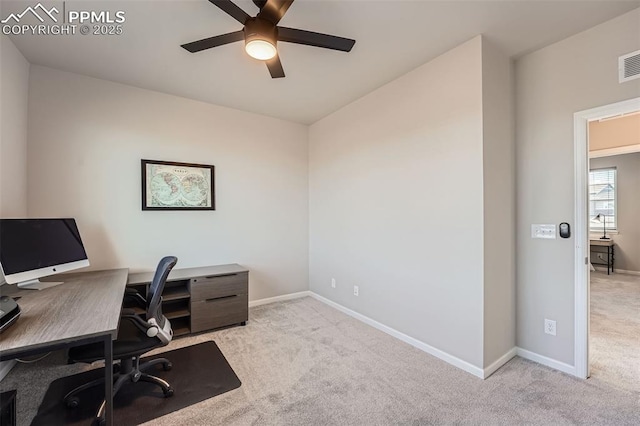 office space featuring ceiling fan and light carpet