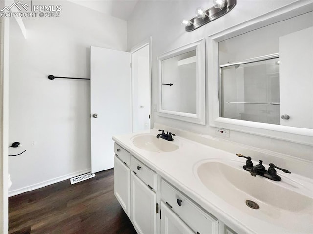 bathroom with vanity, hardwood / wood-style floors, and an enclosed shower