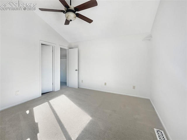 unfurnished bedroom with vaulted ceiling, light colored carpet, and ceiling fan