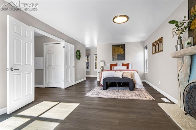 bedroom with dark hardwood / wood-style flooring and multiple windows