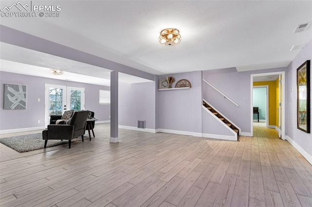 interior space with light hardwood / wood-style flooring and french doors