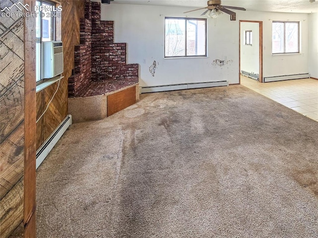 unfurnished living room with carpet, a wealth of natural light, and baseboard heating