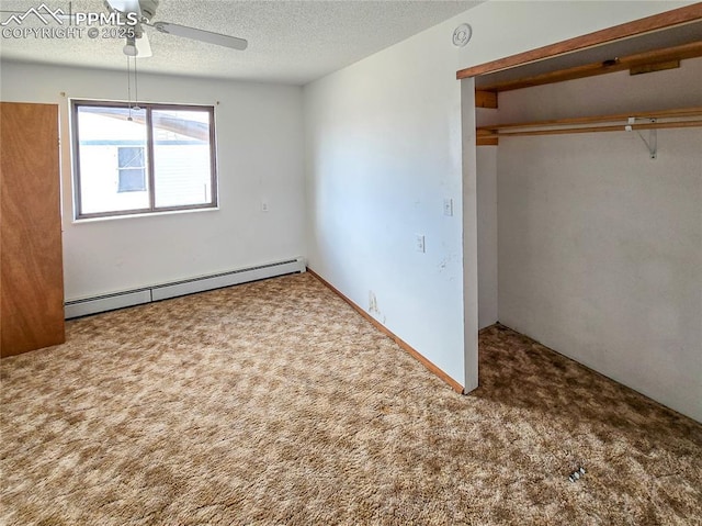 unfurnished bedroom featuring ceiling fan, baseboard heating, carpet, a textured ceiling, and a closet