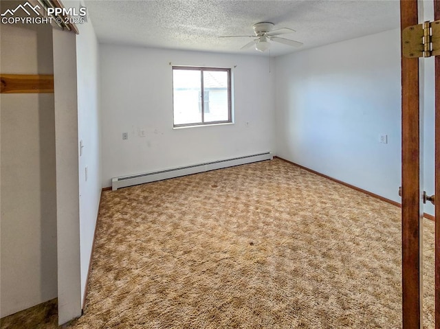 carpeted spare room featuring ceiling fan, a textured ceiling, and a baseboard heating unit