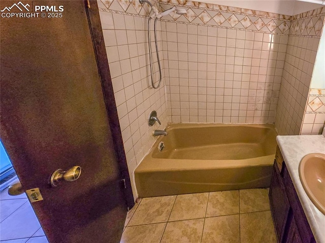 bathroom with tiled shower / bath, tile patterned floors, and vanity