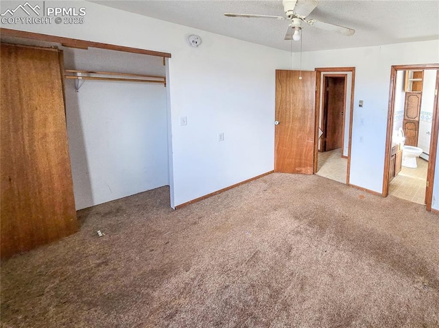 unfurnished bedroom featuring ensuite bath, light carpet, a textured ceiling, a closet, and ceiling fan