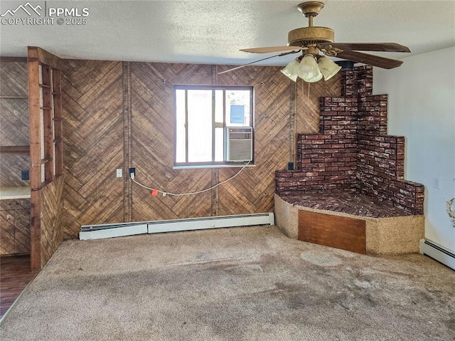 interior space with a baseboard heating unit, carpet floors, a textured ceiling, and ceiling fan