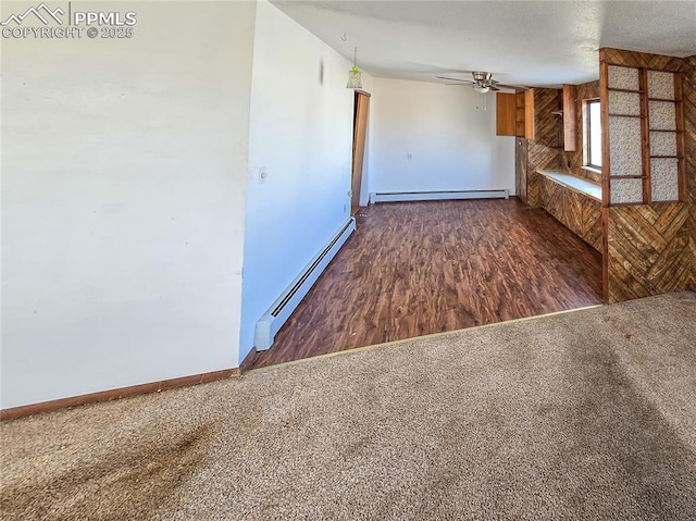 kitchen with dark colored carpet, ceiling fan, and baseboard heating