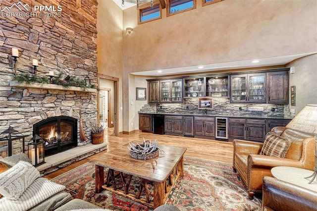 201 Fox Mountain Dr, Woodland Park, CO 80863 - living room with bar, a fireplace, beverage cooler, and light wood-type flooring