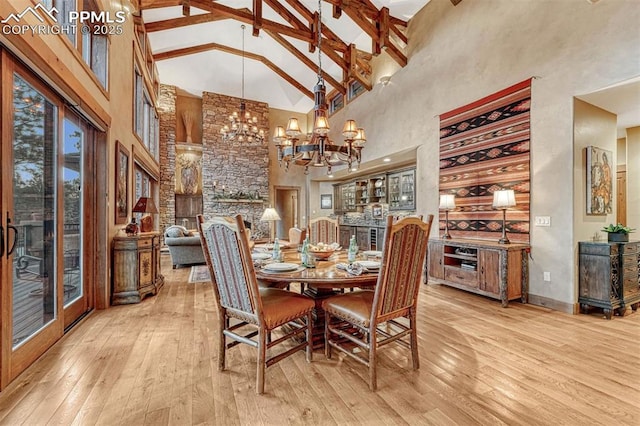 201 Fox Mountain Dr, Woodland Park, CO 80863 - dining space with beam ceiling, a chandelier, high vaulted ceiling, and light hardwood / wood-style flooring