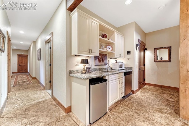 201 Fox Mountain Dr, Woodland Park, CO 80863 - kitchen featuring sink, white cabinetry, refrigerator, stainless steel dishwasher, and light stone countertops