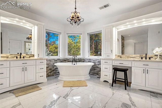 bathroom featuring vanity, tile walls, an inviting chandelier, and a tub to relax in